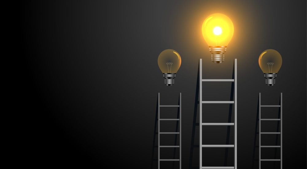 success concept ladder with glowing light bulb